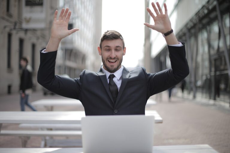 Blog 24 businessman hands in the air happy
