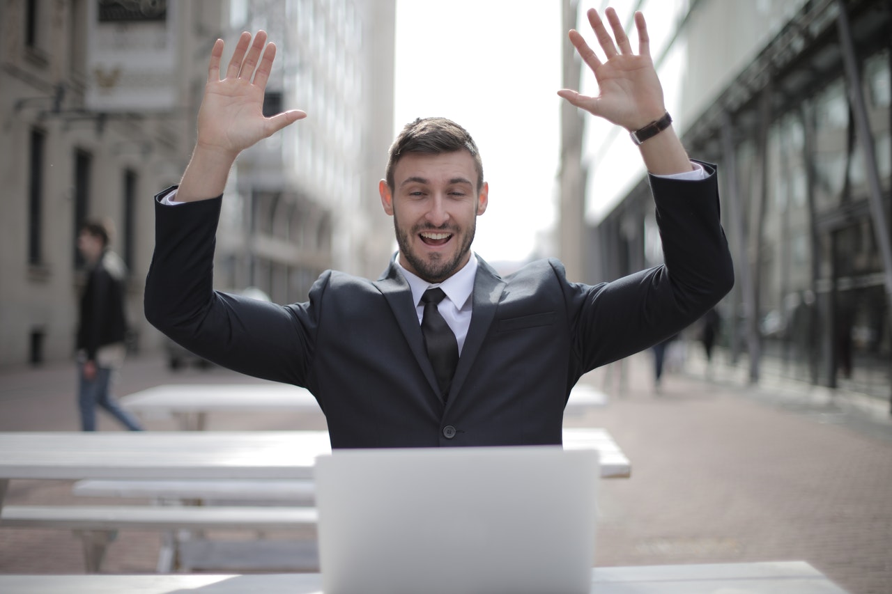 Multilingual Websites 3 businessman hands in the air happy